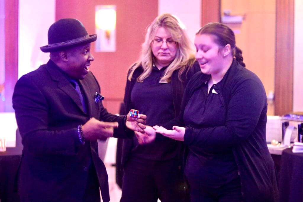Indianapolis magician performing interactive magic at a corporate event, entertaining professionals with close-up illusions.