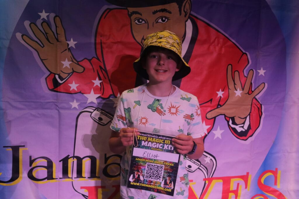 Child showing off magic trick during Indianapolis summer camp program