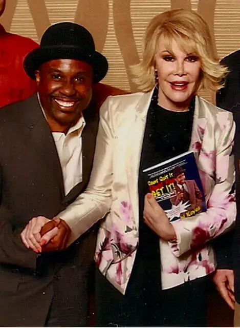 Joan Rivers smiling with comedy magician Jamahl Keyes after an unforgettable live theater performance in the lobby.