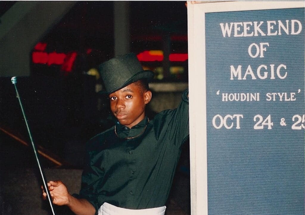 Comedy magician Jamahl Keyes performing an escape artist routine on stage