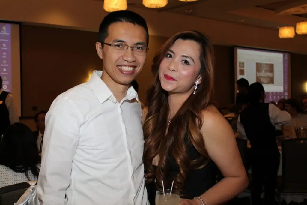 Mr. and Mrs. Chen smiling with Indianapolis magician Jamahl Keyes at their Fishers, Indiana birthday celebration filled with laughter and magic.