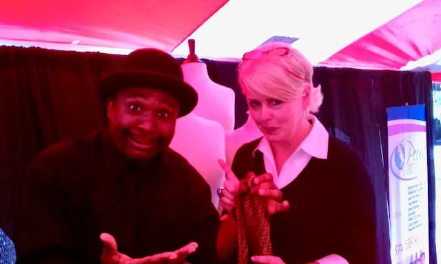 The Magic Comic Jamahl Keyes shares a laugh with Project Runway’s Peach Carr backstage at the Indianapolis Convention Center as she helps him choose a tie before hosting the runway show.